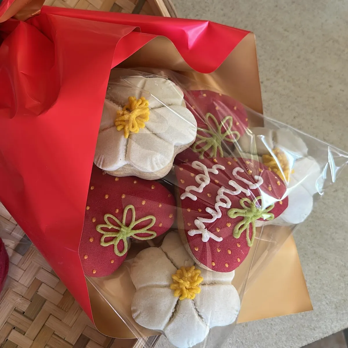 A concha bouquet wrapped in red paper with flower and strawberry decorated conchas
